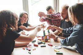 group-creative-friends-sitting-wooden-table-people-were-having-fun-while-playing-board-game_146671-15242.jpg
